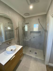 After photo of the Coburg bathroom renovation showing modern walk-in shower, timber vanity and vessel basin
